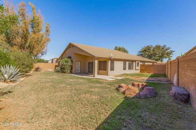 29900 N Maravilla Dr, San Tan Valley, AZ 85143 - back of property featuring a yard, a patio area, stucco siding, and a fenced backyard