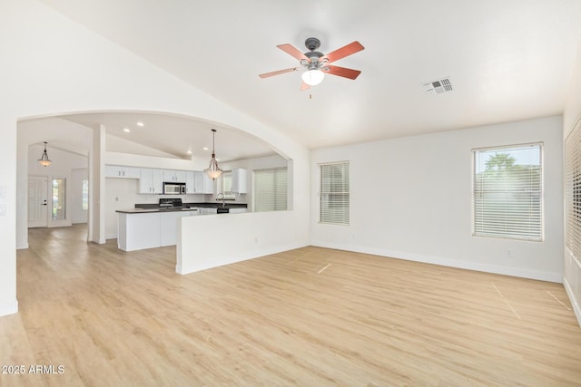 29900 N Maravilla Dr, San Tan Valley, AZ 85143 - unfurnished living room with visible vents, light wood-style flooring, a ceiling fan, baseboards, and lofted ceiling