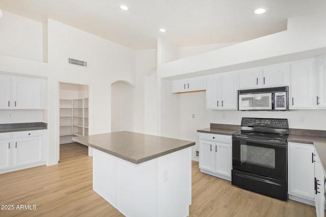 29900 N Maravilla Dr, San Tan Valley, AZ 85143 - kitchen featuring stainless steel microwave, electric range, dark countertops, and white cabinetry