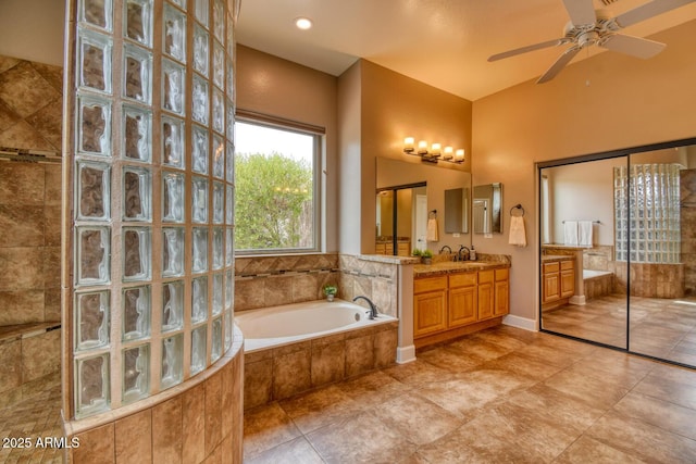 full bathroom featuring vanity, walk in shower, tile patterned floors, a bath, and a ceiling fan