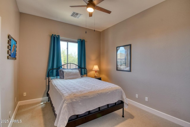 bedroom featuring light colored carpet, baseboards, visible vents, and a ceiling fan