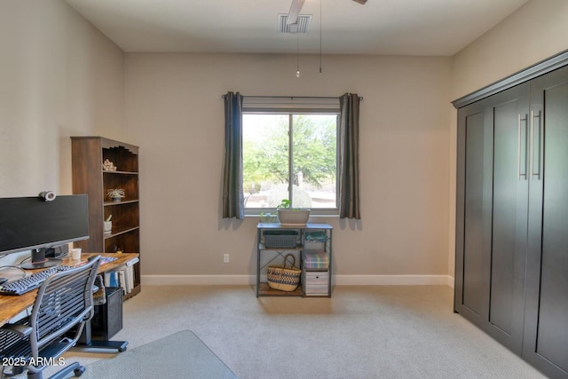 home office featuring visible vents, baseboards, ceiling fan, and light colored carpet