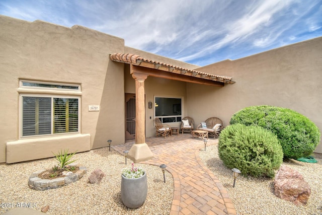 back of property featuring a patio and stucco siding