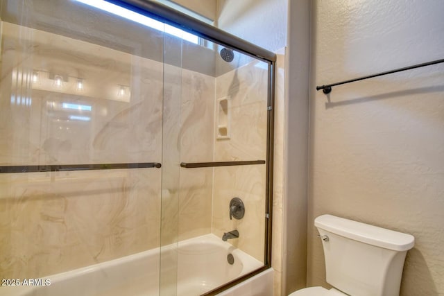full bath featuring shower / bath combination with glass door and toilet