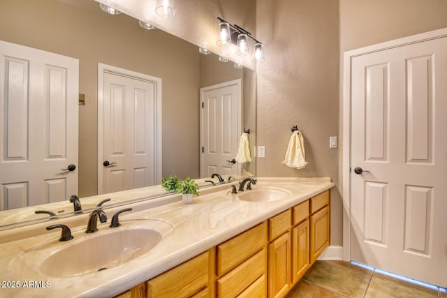 bathroom featuring a sink, tile patterned floors, and double vanity