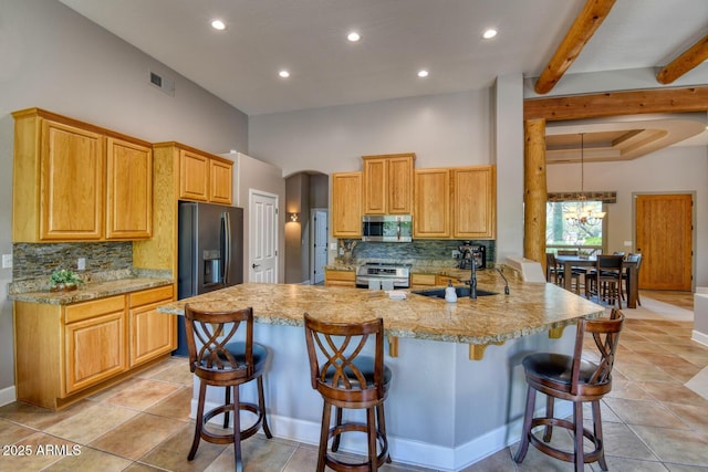 kitchen with visible vents, a sink, decorative backsplash, and appliances with stainless steel finishes
