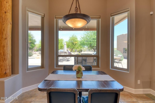 dining area with baseboards and light tile patterned floors