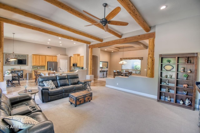living room featuring beamed ceiling, baseboards, recessed lighting, light colored carpet, and ceiling fan with notable chandelier