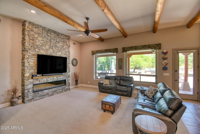 living room featuring baseboards, a ceiling fan, a fireplace, and beamed ceiling