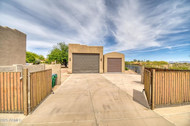 view of home's exterior featuring fence, a gate, and stucco siding