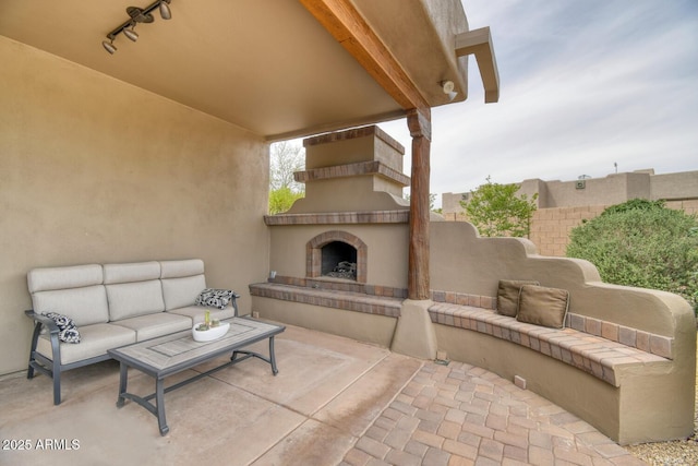 view of patio / terrace featuring an outdoor living space with a fireplace