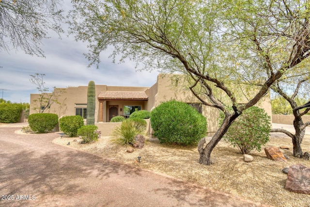 view of front of property with stucco siding and a tile roof