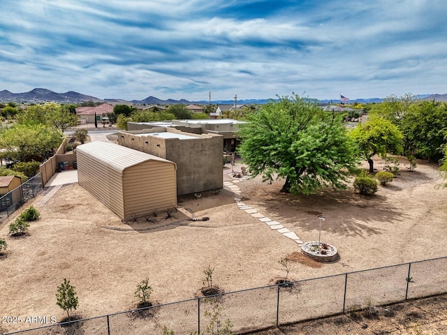 view of yard with fence and a mountain view