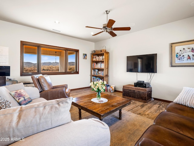 living room with hardwood / wood-style floors and ceiling fan