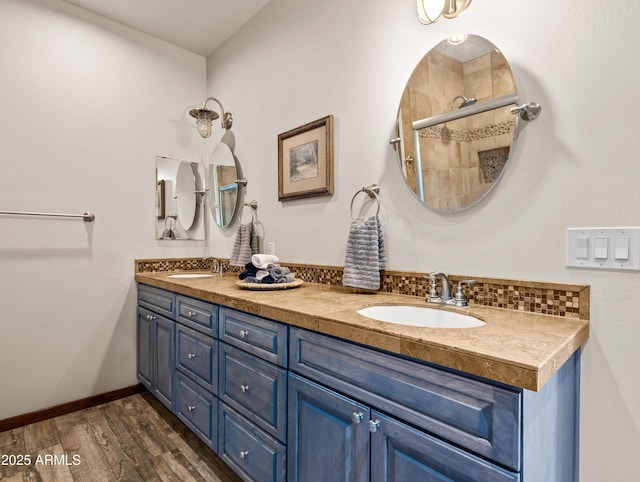 bathroom featuring wood-type flooring, vanity, and walk in shower