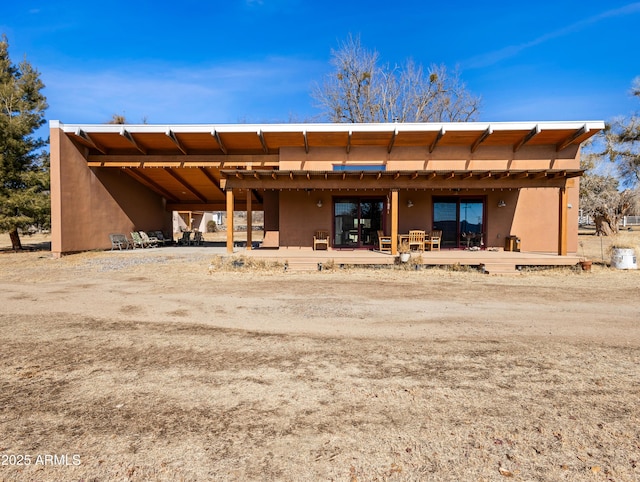 back of house with a wooden deck