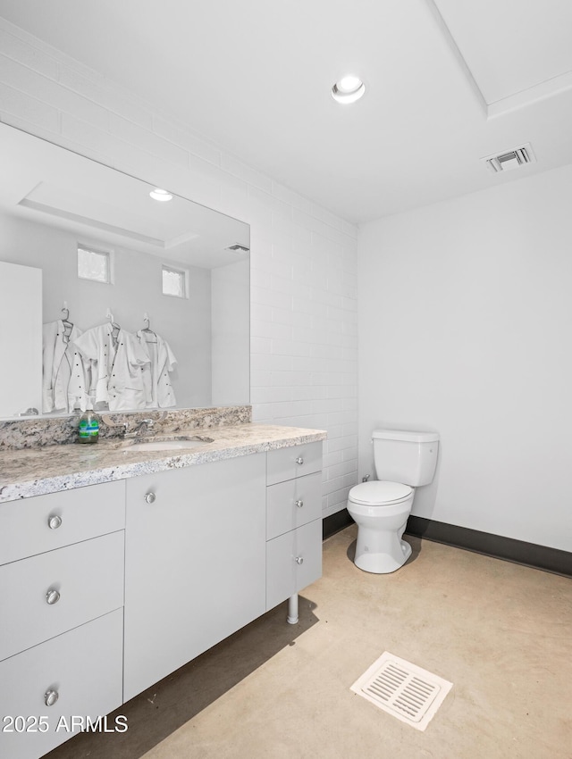 bathroom featuring toilet and vanity