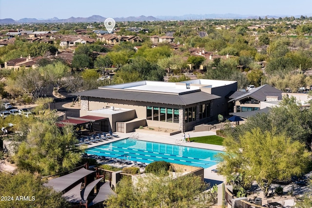 outdoor pool with a patio area and a mountain view