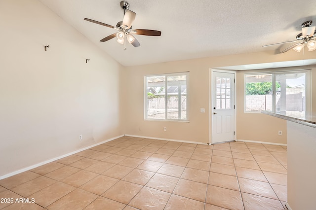 unfurnished room featuring light tile patterned flooring, ceiling fan, lofted ceiling, and baseboards
