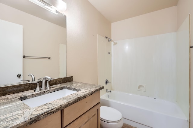 bathroom with vanity, toilet, and  shower combination