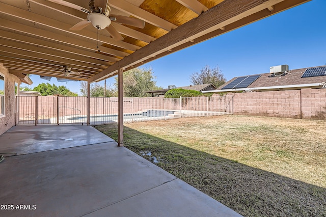 view of yard with a patio area, a fenced in pool, a fenced backyard, cooling unit, and a ceiling fan
