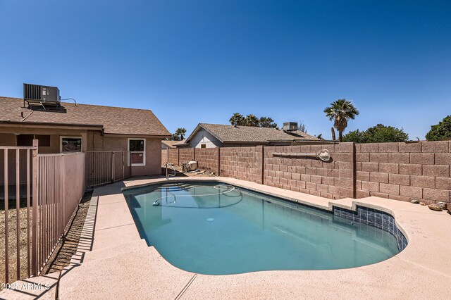 view of pool featuring a fenced backyard, cooling unit, and a fenced in pool