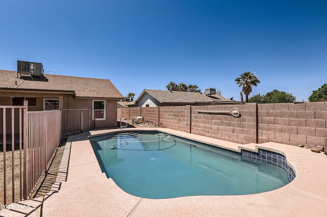 view of pool featuring a fenced backyard, cooling unit, and a fenced in pool