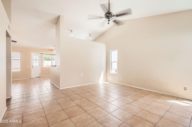 unfurnished room with light tile patterned floors, a ceiling fan, and baseboards
