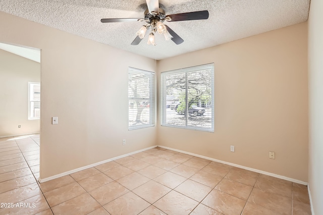 unfurnished room with baseboards, light tile patterned floors, a ceiling fan, and a textured ceiling