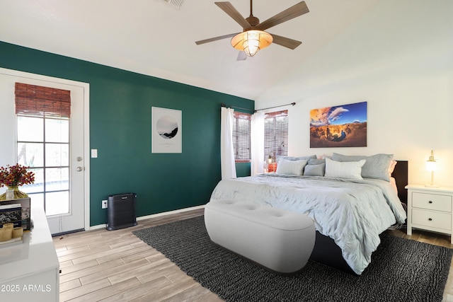 bedroom with light wood-style flooring, vaulted ceiling, baseboards, and ceiling fan