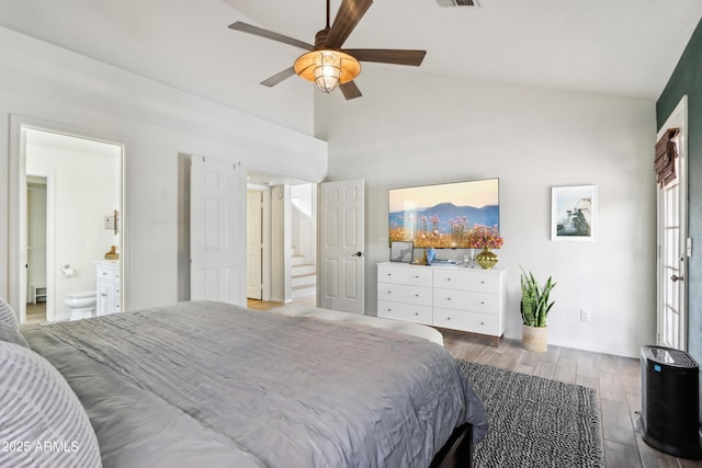 bedroom featuring wood finished floors, connected bathroom, high vaulted ceiling, a ceiling fan, and baseboards