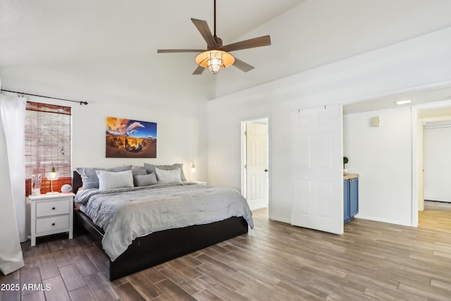 bedroom with wood finished floors, high vaulted ceiling, ceiling fan, and baseboards