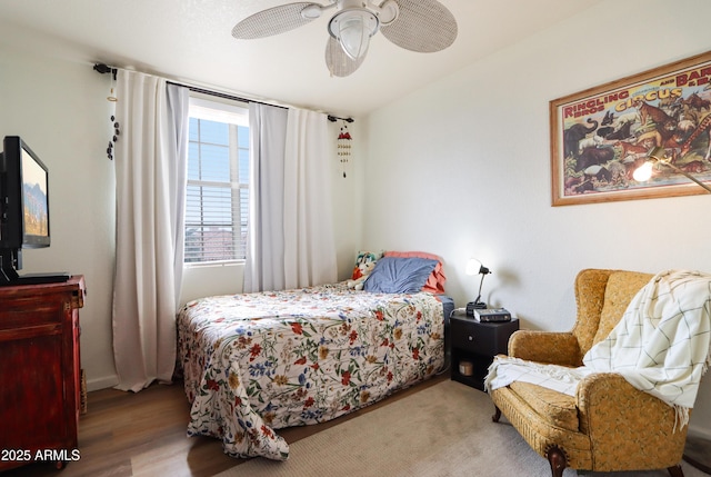 bedroom featuring wood finished floors and ceiling fan