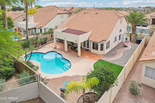 view of swimming pool with a fenced backyard, a patio area, and a residential view