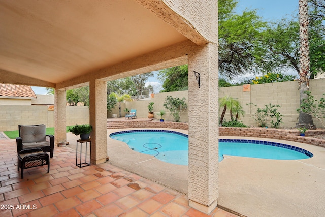 view of swimming pool with a patio and a fenced backyard
