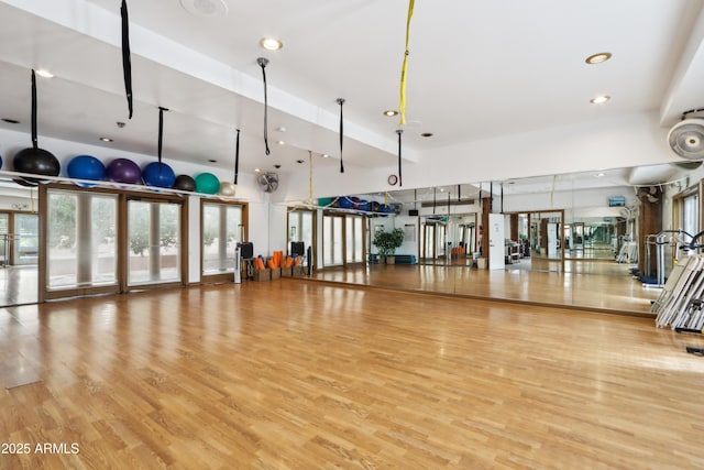 workout area with wood finished floors and recessed lighting