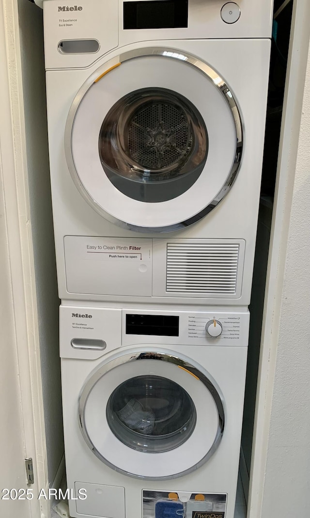 laundry room with stacked washer / drying machine