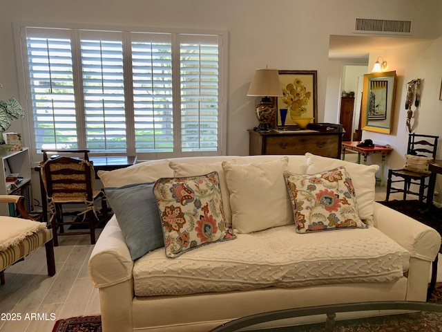 living room with plenty of natural light and wood finished floors