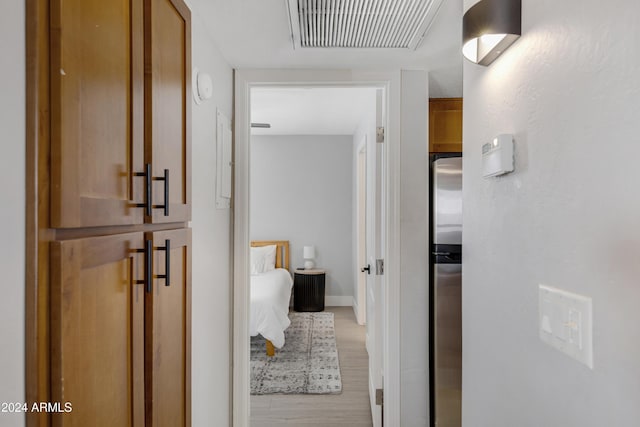 hallway with light hardwood / wood-style floors