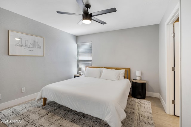 bedroom with light hardwood / wood-style floors and ceiling fan