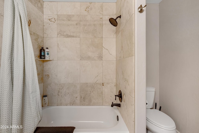 bathroom with toilet and shower / tub combo with curtain