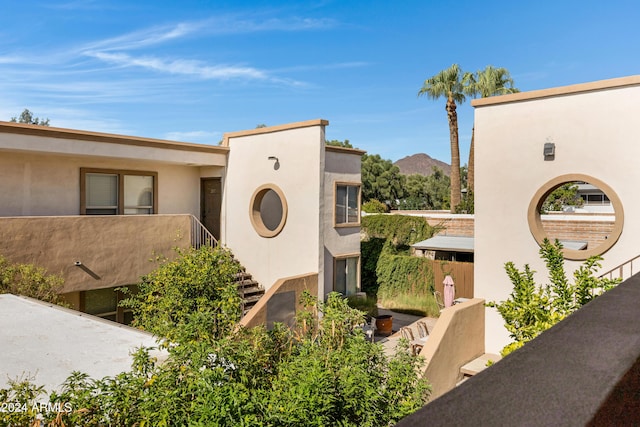 view of front of home featuring a mountain view and a balcony