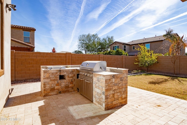 view of patio / terrace featuring area for grilling and a grill