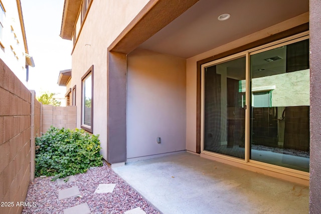 property entrance featuring a patio