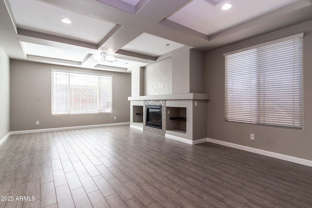 unfurnished living room with coffered ceiling and beam ceiling