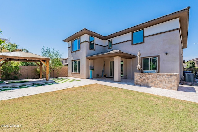 back of house with a gazebo, a lawn, central AC, and a patio