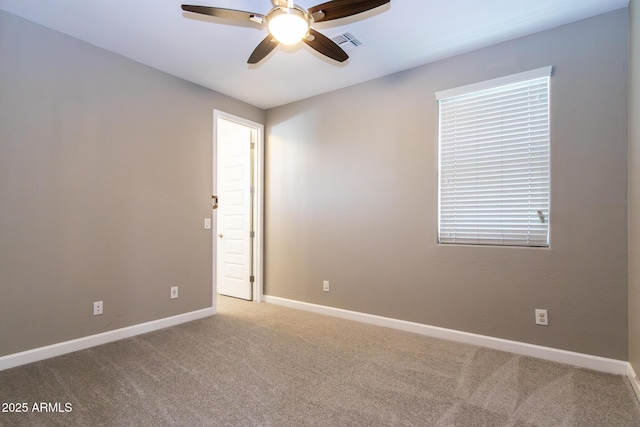 carpeted spare room featuring ceiling fan