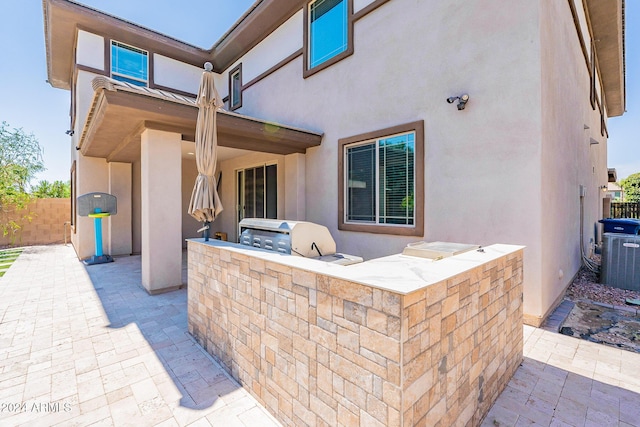 view of patio / terrace featuring an outdoor kitchen and cooling unit