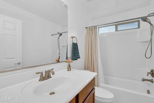 bathroom with shower / tub combo with curtain, vanity, and toilet