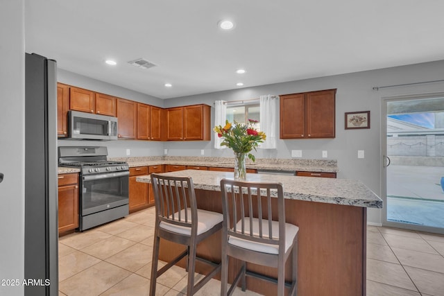 kitchen featuring light tile patterned flooring, recessed lighting, visible vents, and appliances with stainless steel finishes